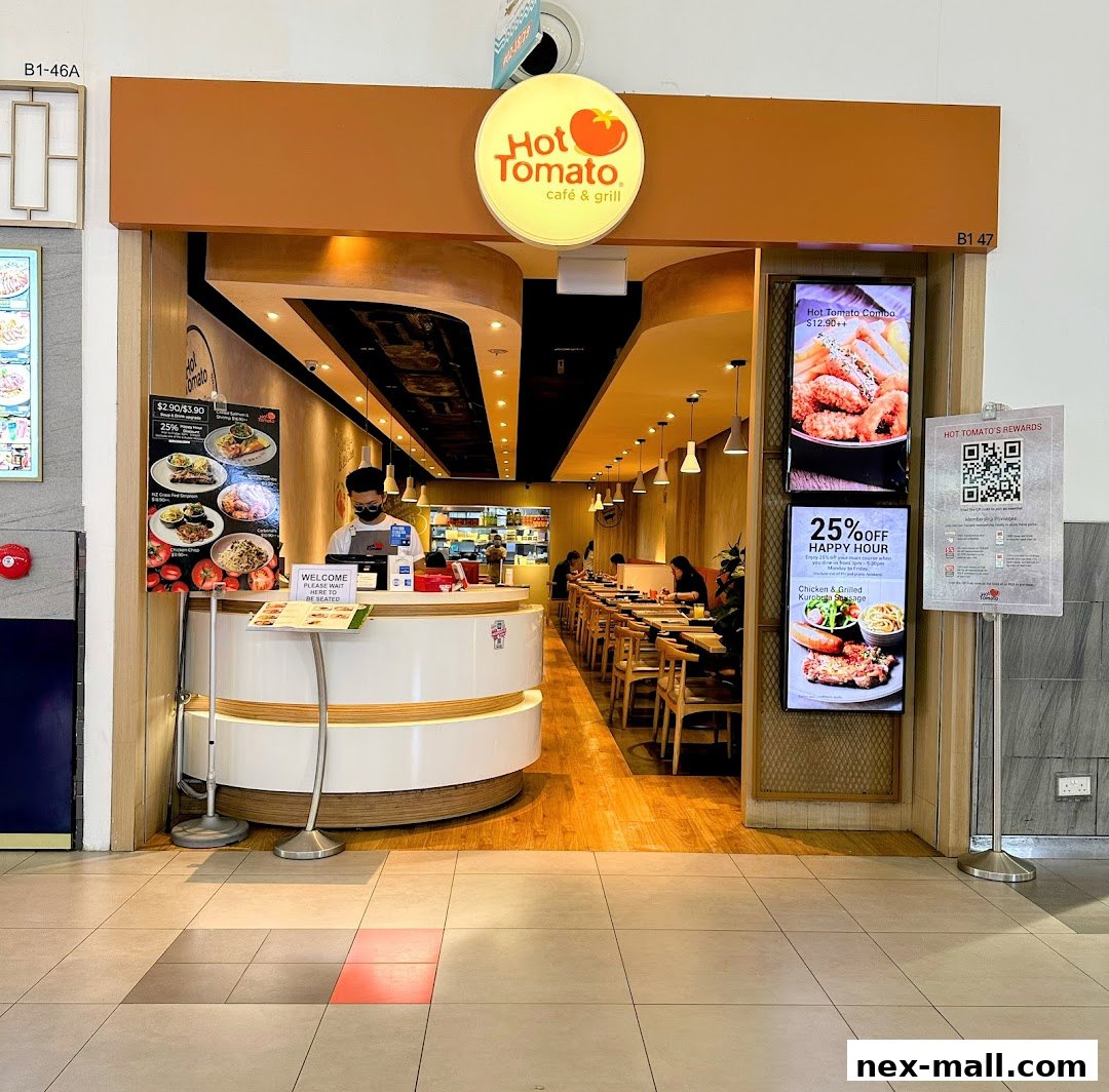 The entrance to Hot Tomato Cafe & Grill, featuring a welcome counter and dining area.