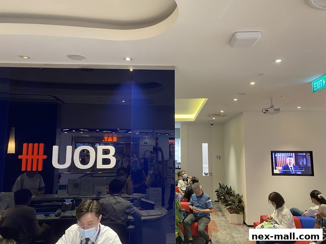 Interior of a UOB bank branch with customers waiting and staff at counters.