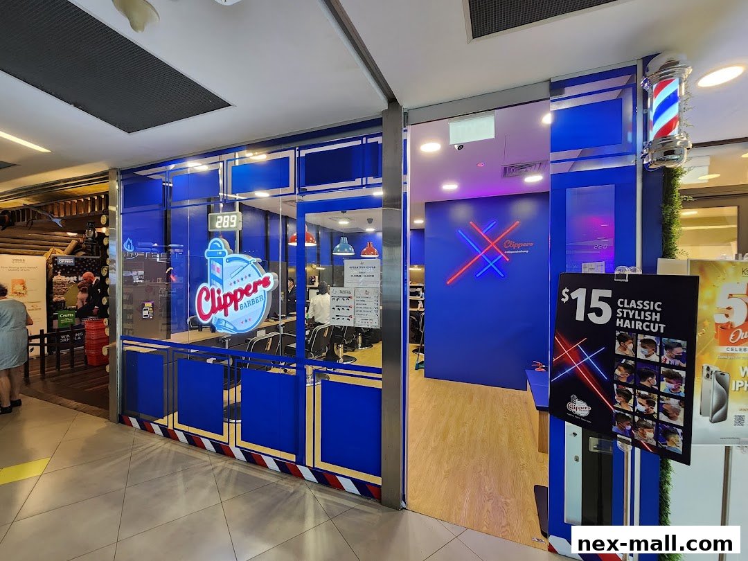 The exterior of Clippers Barber shop with blue and white branding and a barber pole.