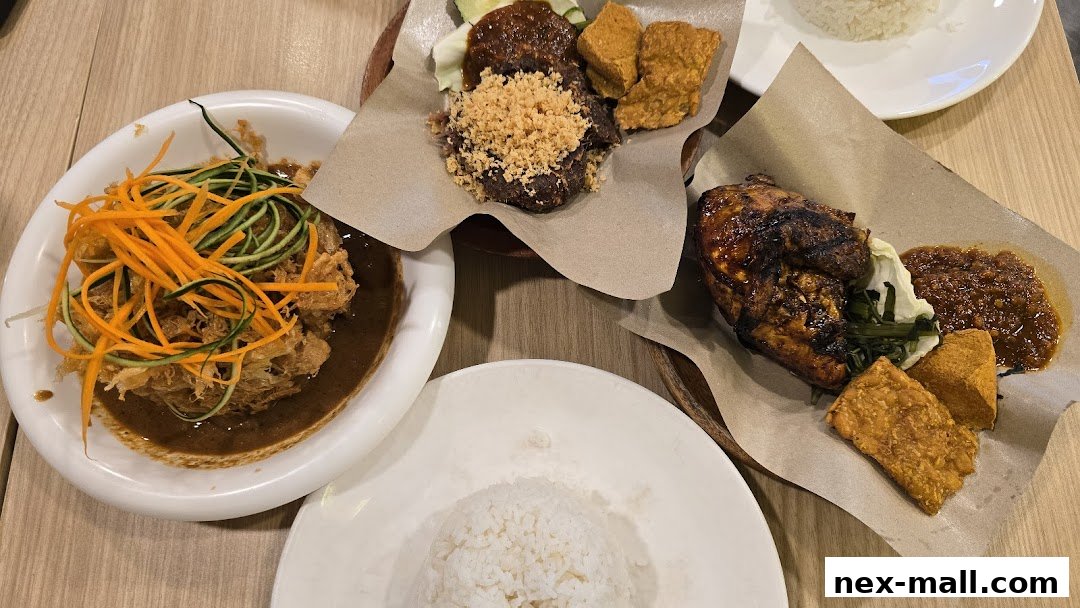 A spread of Indonesian dishes including grilled chicken, fried items, and rice.