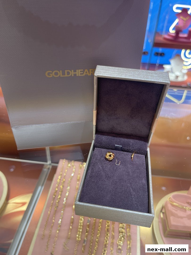 A jewelry box with earrings and a shopping bag from Goldheart Jewelry.