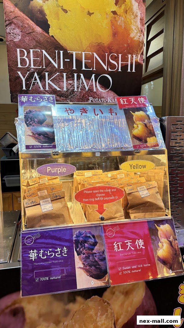 A display of various types of baked sweet potatoes, labeled as Beni-Tenshi Yaki-imo.