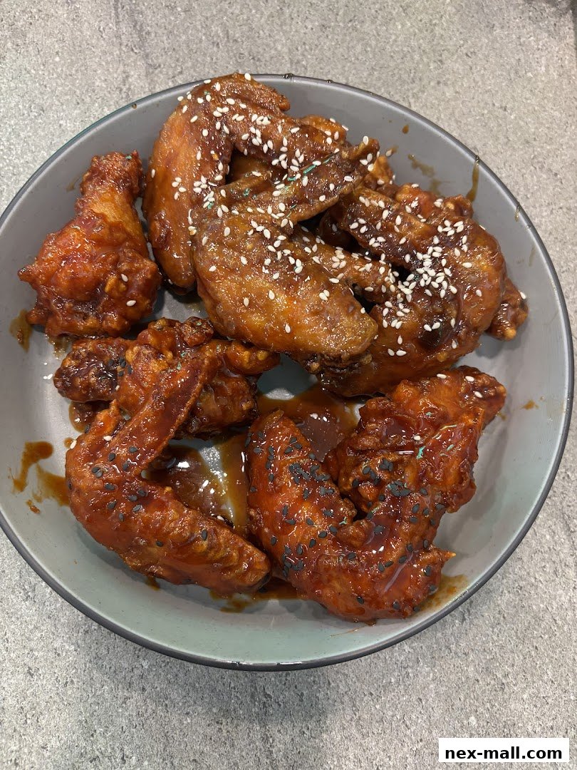 A bowl of delicious Korean fried chicken wings with sesame seeds.