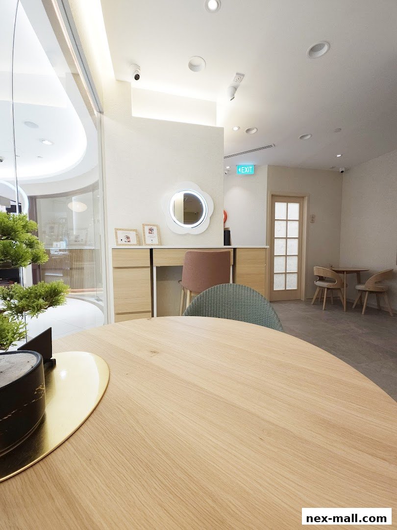 Interior view of a modern beauty salon with a vanity, seating, and decorative elements.