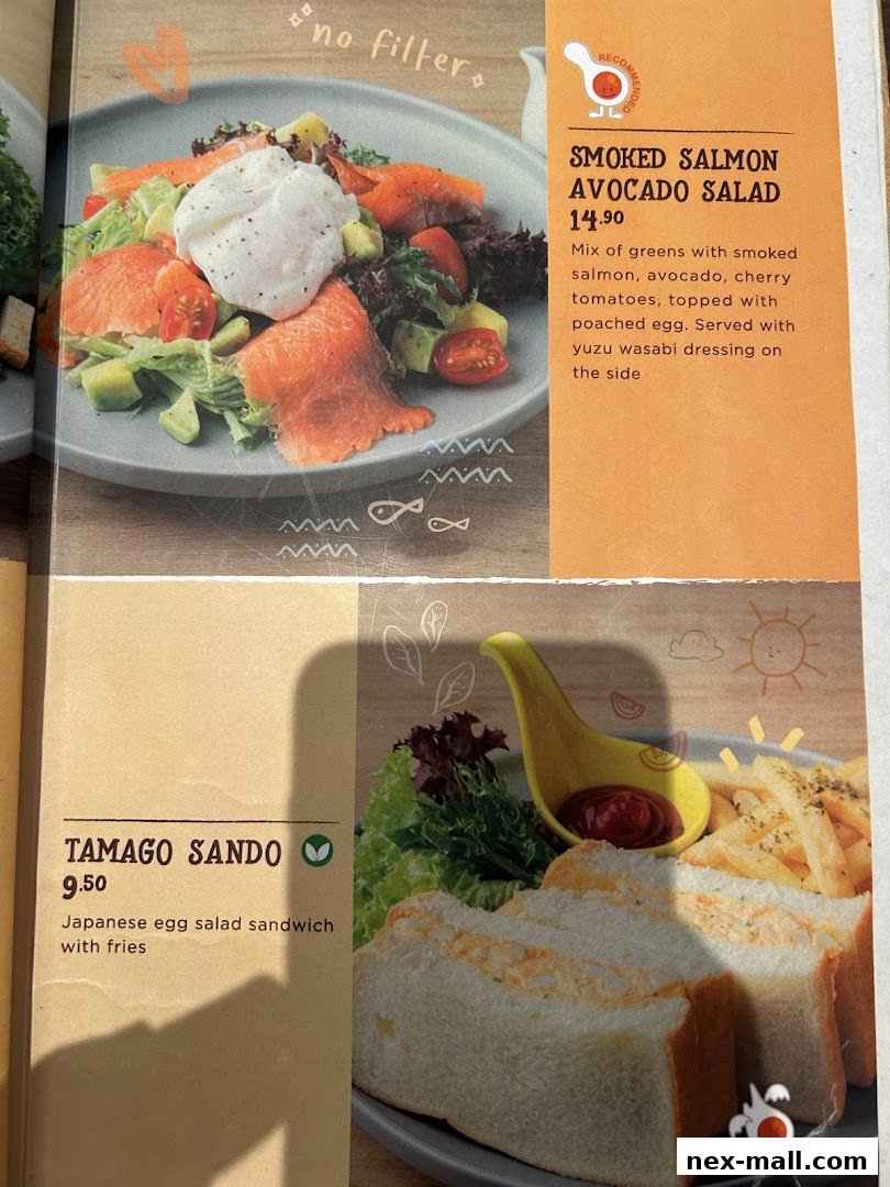 A menu page showcasing a smoked salmon avocado salad and a tamago sando with fries.