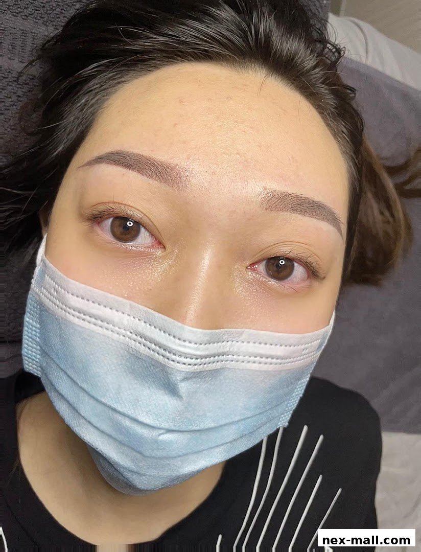 Close-up of a woman with newly done eyebrows and a face mask.