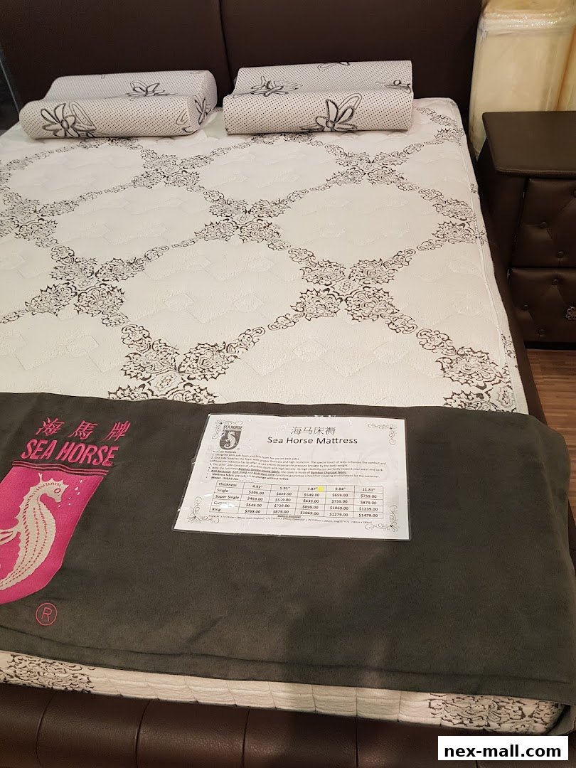A Sea Horse brand mattress with pillows and a price list on a dark brown bed frame.
