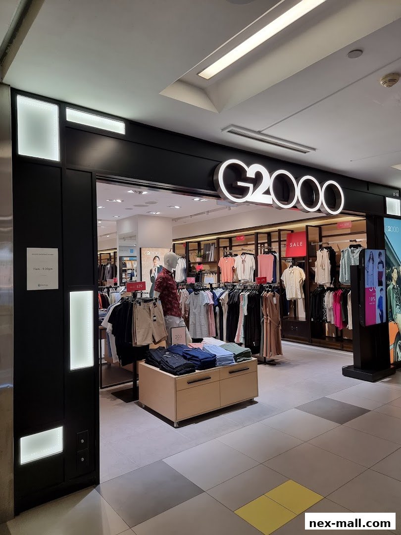 The G2000 shop front displays a variety of men's and women's clothing, including shirts, dresses, and shorts.