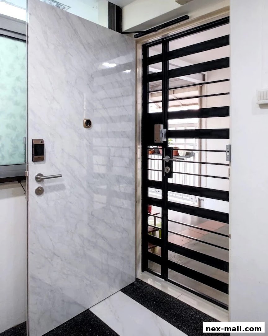 A modern marble-patterned door with a digital lock and a black metal gate.