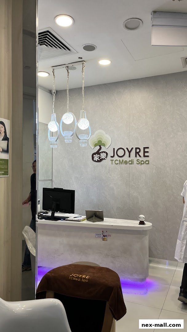 The reception area of Joyre TCMedi Spa with a counter, computer, and decorative lighting.