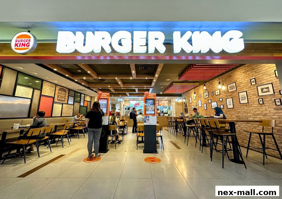 The interior of a Burger King restaurant with seating areas and a counter.