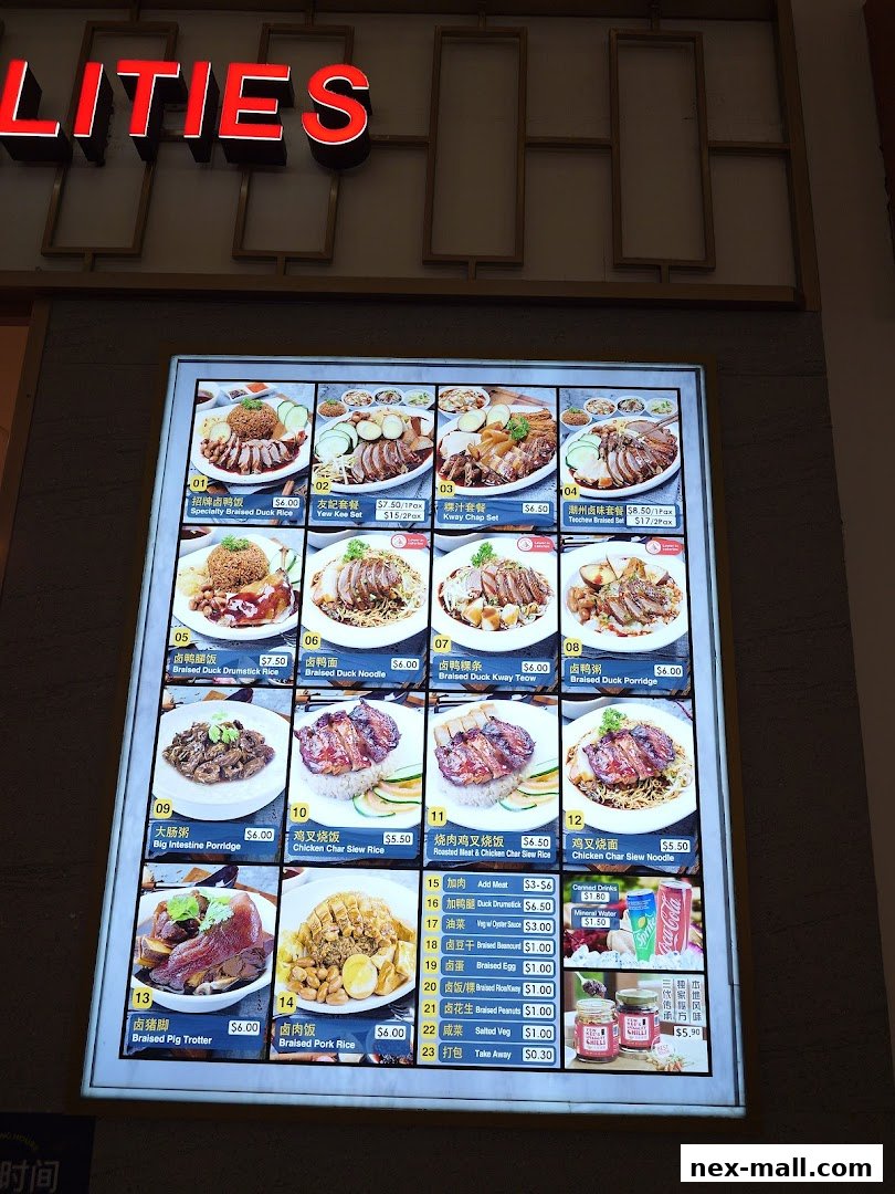 A brightly lit menu board displays various braised duck and pork dishes with prices.