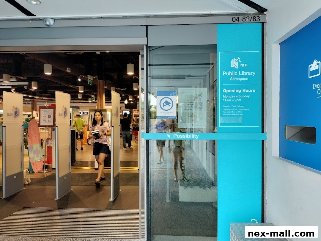 Entrance to Serangoon Public Library with people entering and a sign displaying opening hours.