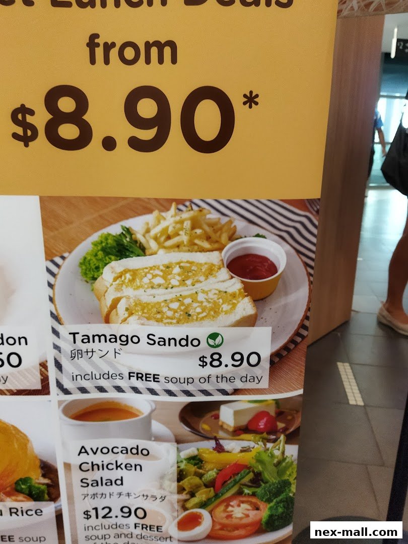 A menu board showcasing Tamago Sando and Avocado Chicken Salad lunch deals.