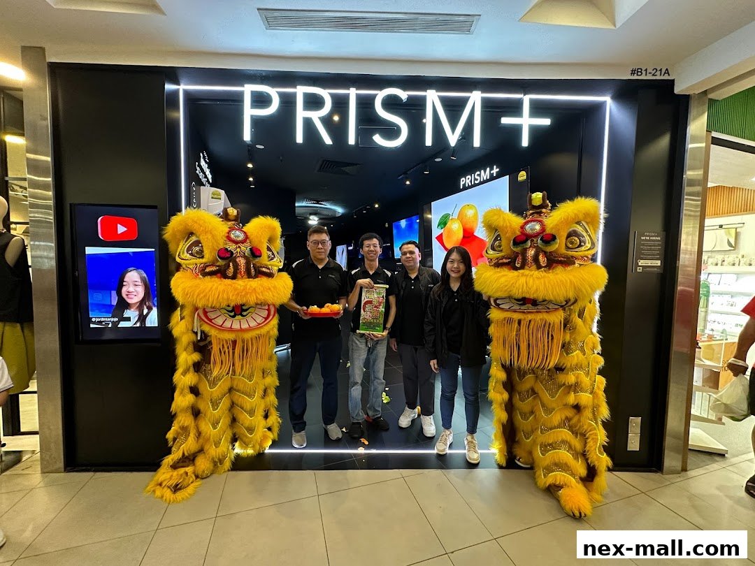PRISM+ store opening with lion dance performance and staff.