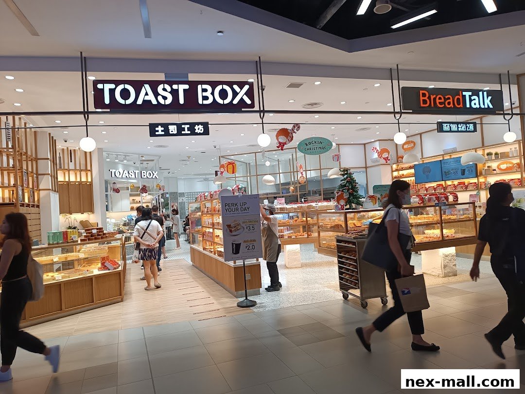 The entrance of Toast Box and BreadTalk shops, showcasing their baked goods and festive decorations.
