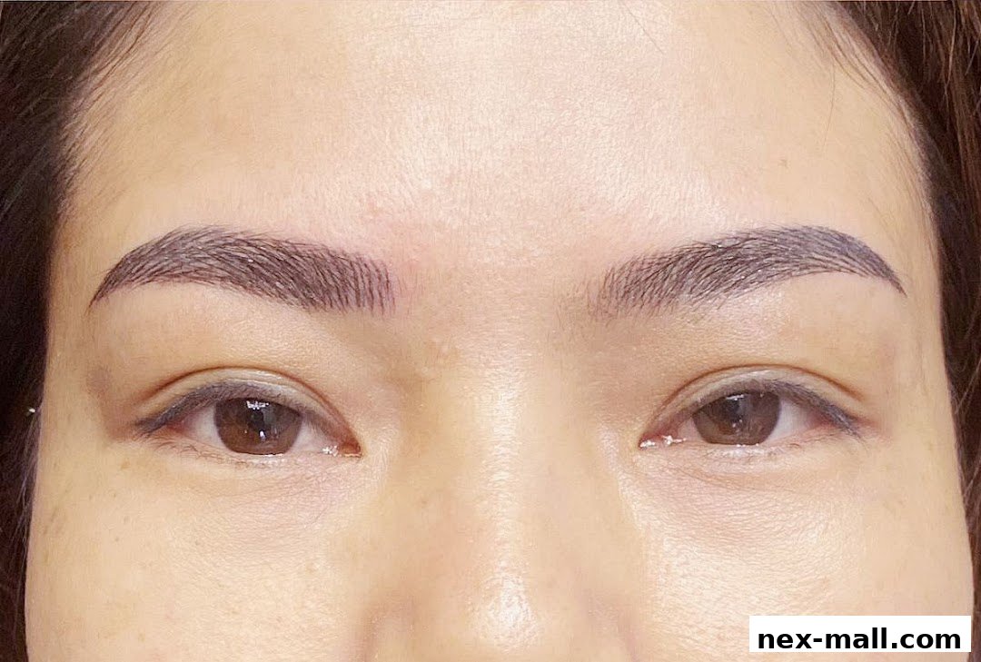 Close-up of a woman's face focusing on her perfectly shaped and filled eyebrows.