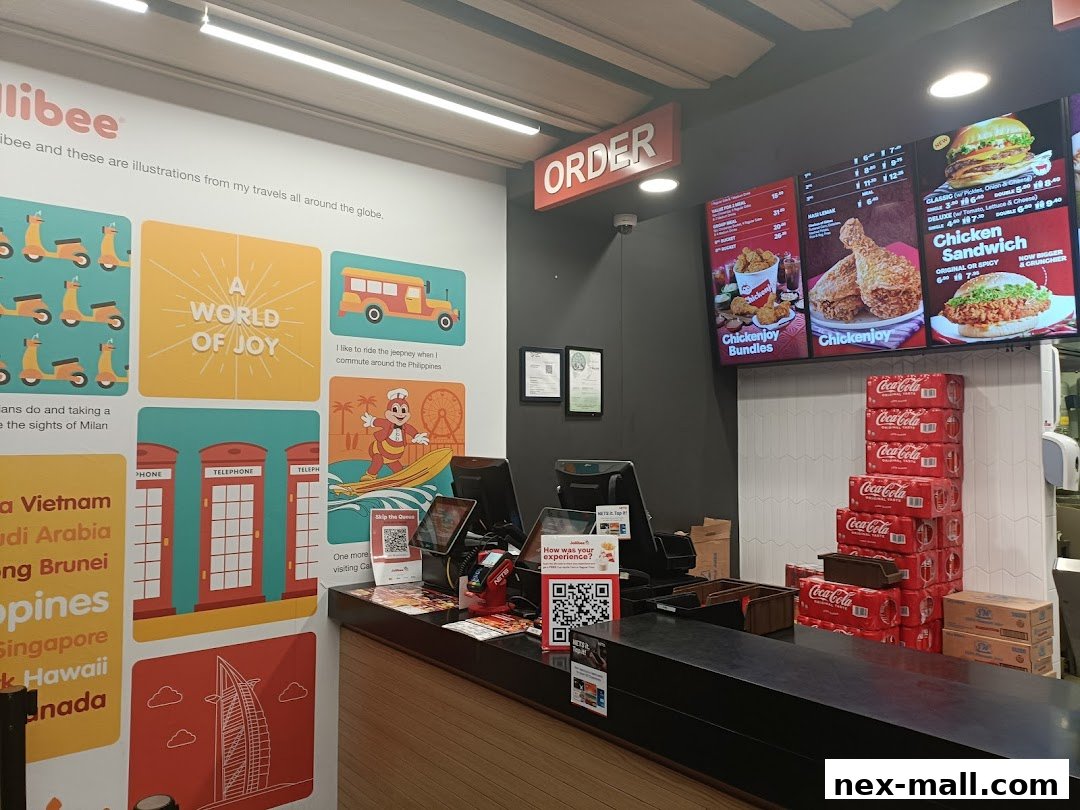 Interior view of a Jollibee restaurant with a menu board, ordering counter, and decorative wall art.
