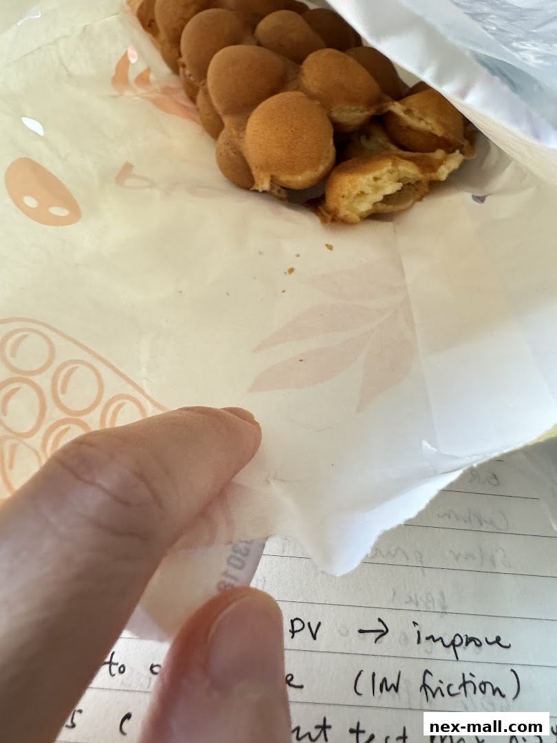 A hand peels back packaging to reveal bubble waffles from PlayMade.