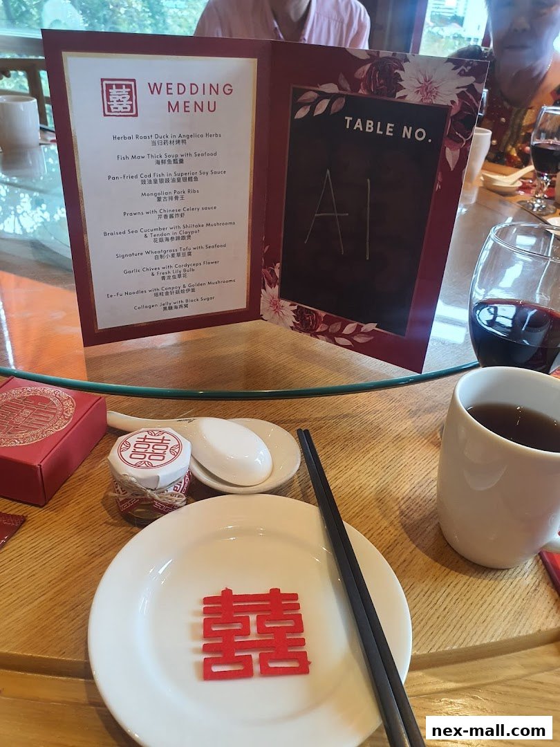 A wedding menu is displayed on a table with place settings and drinks.