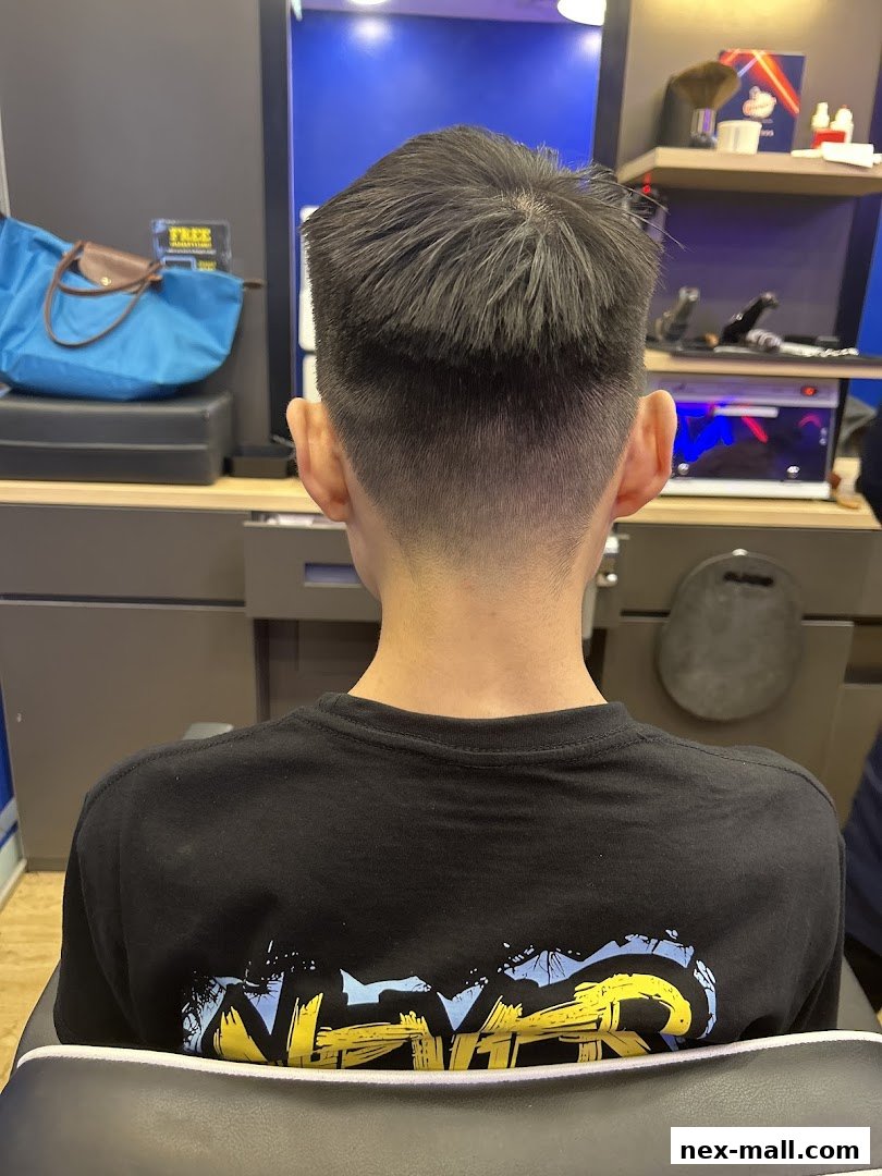 A person's back with a fresh haircut at Clippers Barber NEX.