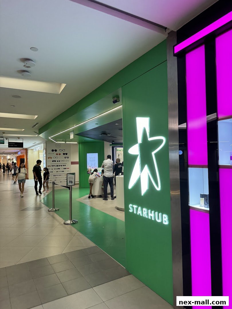 The StarHub shop front with its distinctive green and white logo and bright pink accents.