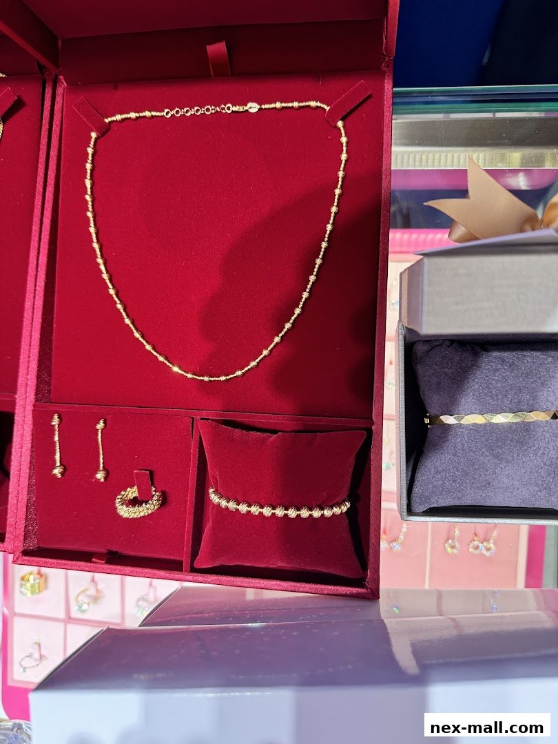 A display of elegant gold jewelry, including necklaces, earrings, rings, and bracelets.