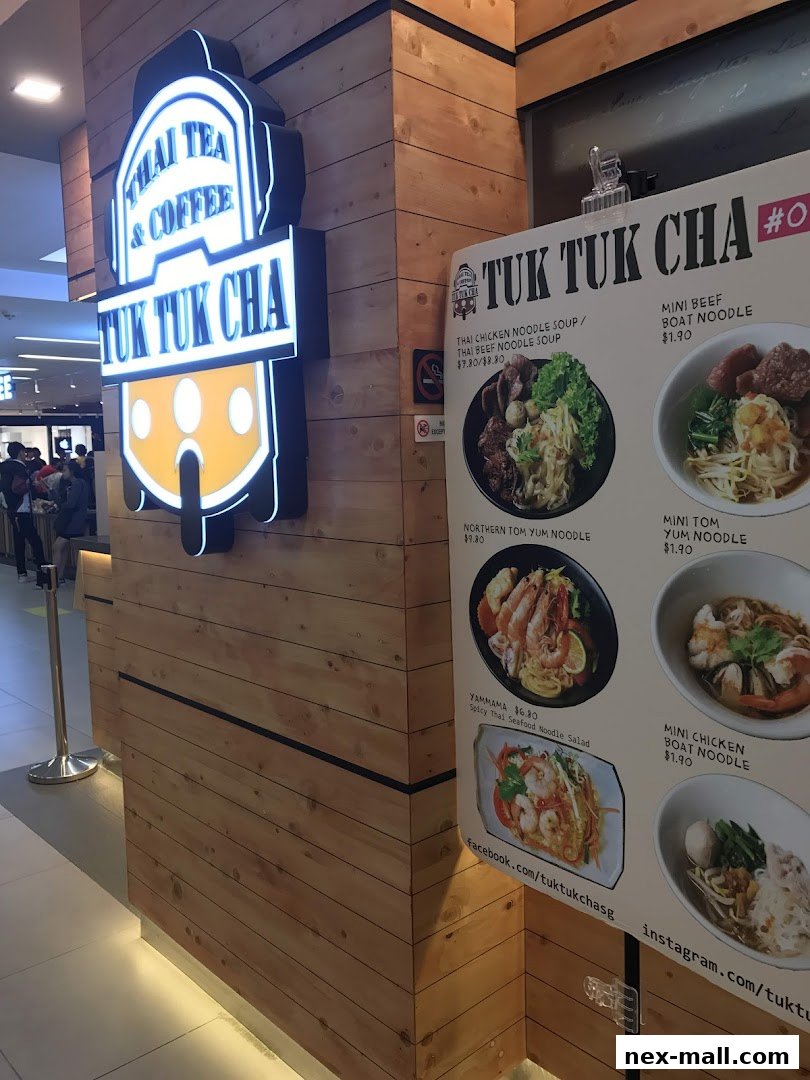 A menu board displaying various Thai noodle dishes and their prices at Tuk Tuk Cha.