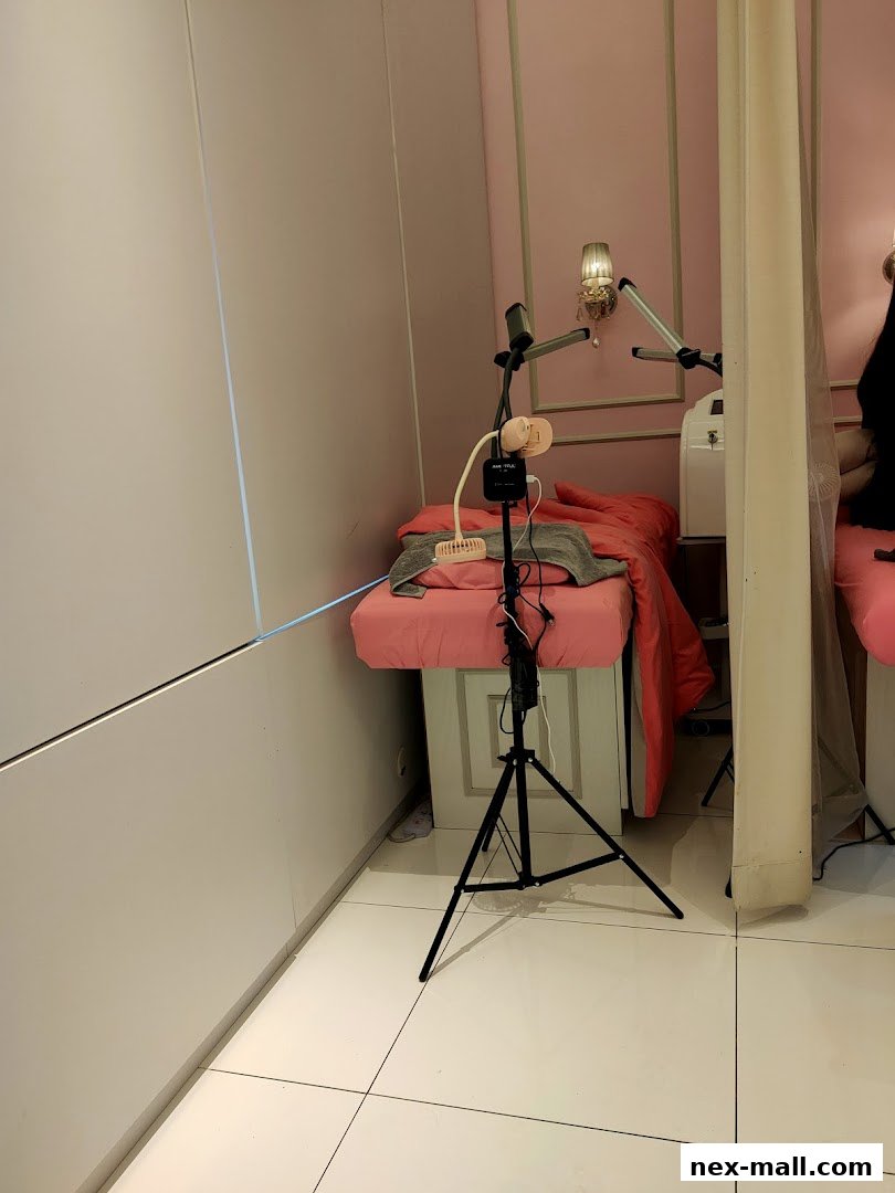 Interior shot of a beauty salon with a treatment bed and equipment.