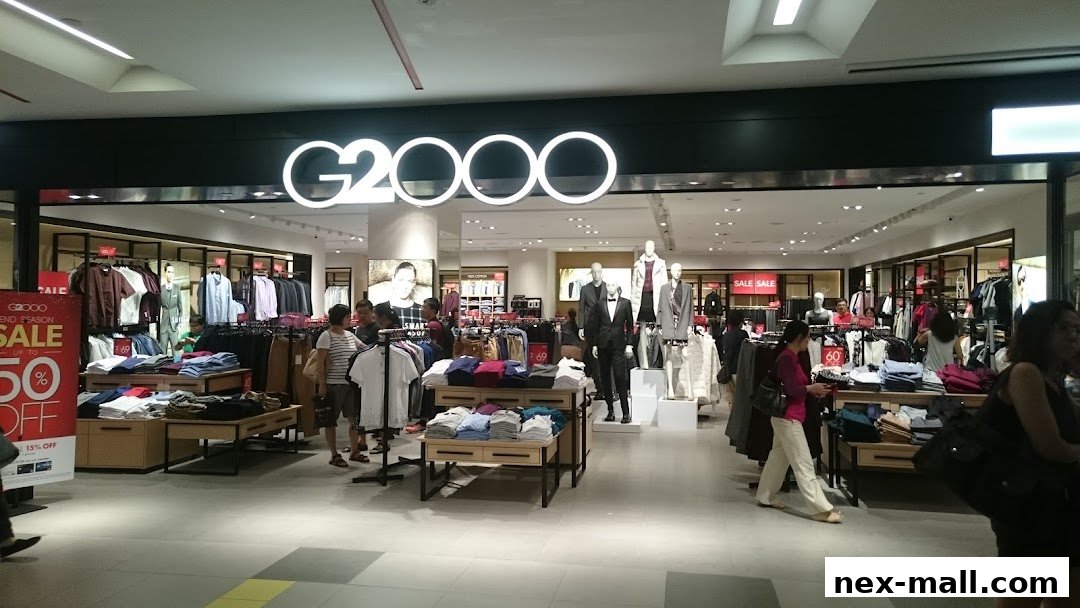 The G2000 store entrance displays clothing on racks and tables, with mannequins showcasing outfits.