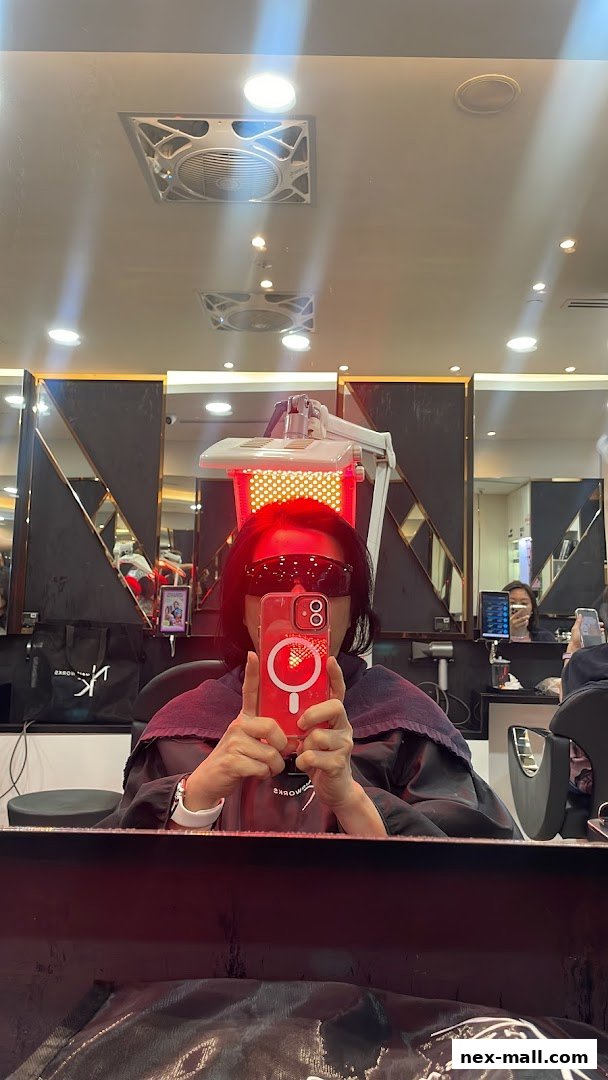 A person is undergoing a red light therapy treatment for hair at NK Hairworks.