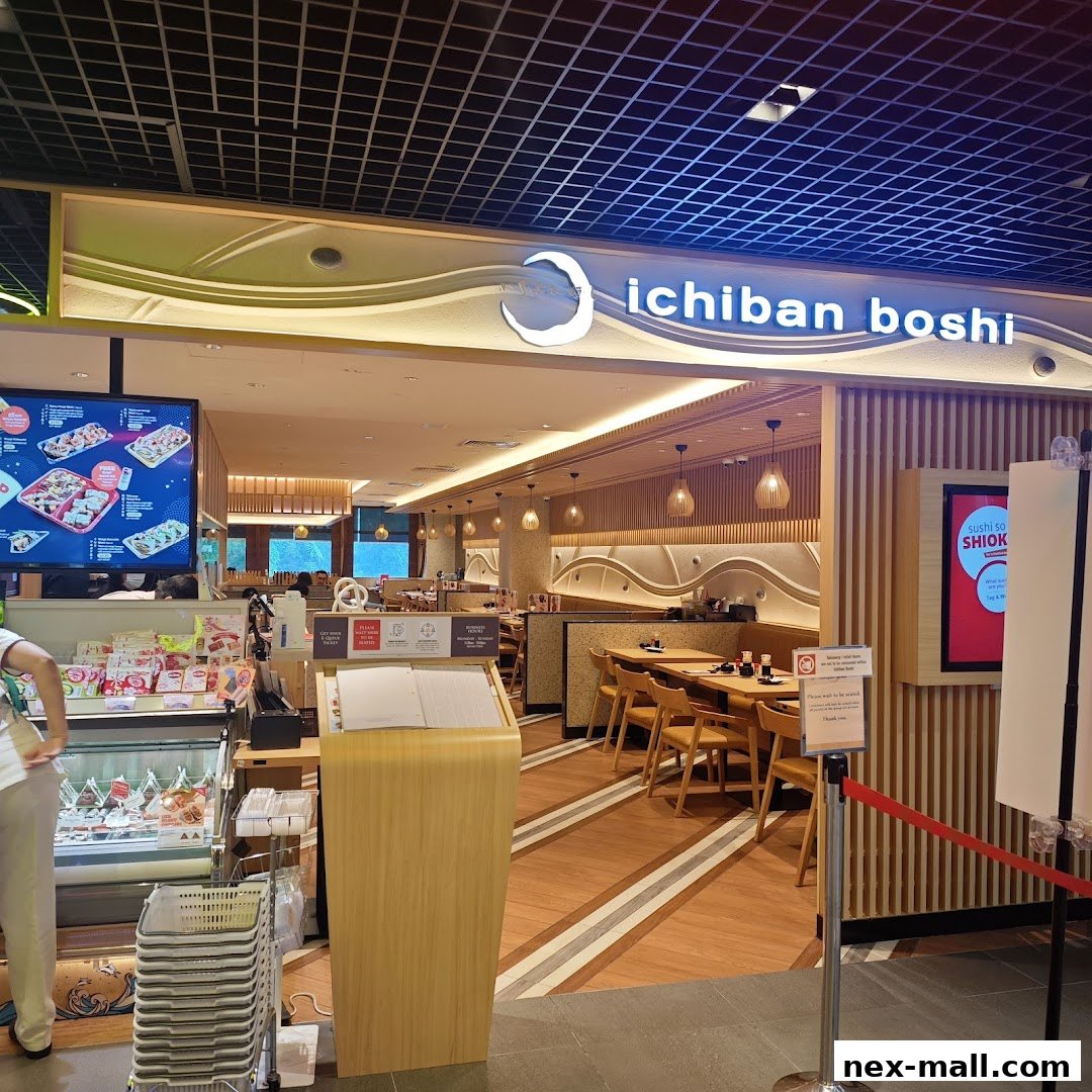The entrance to Ichiban Boshi, a Japanese restaurant, with a display of sushi and seating visible inside.