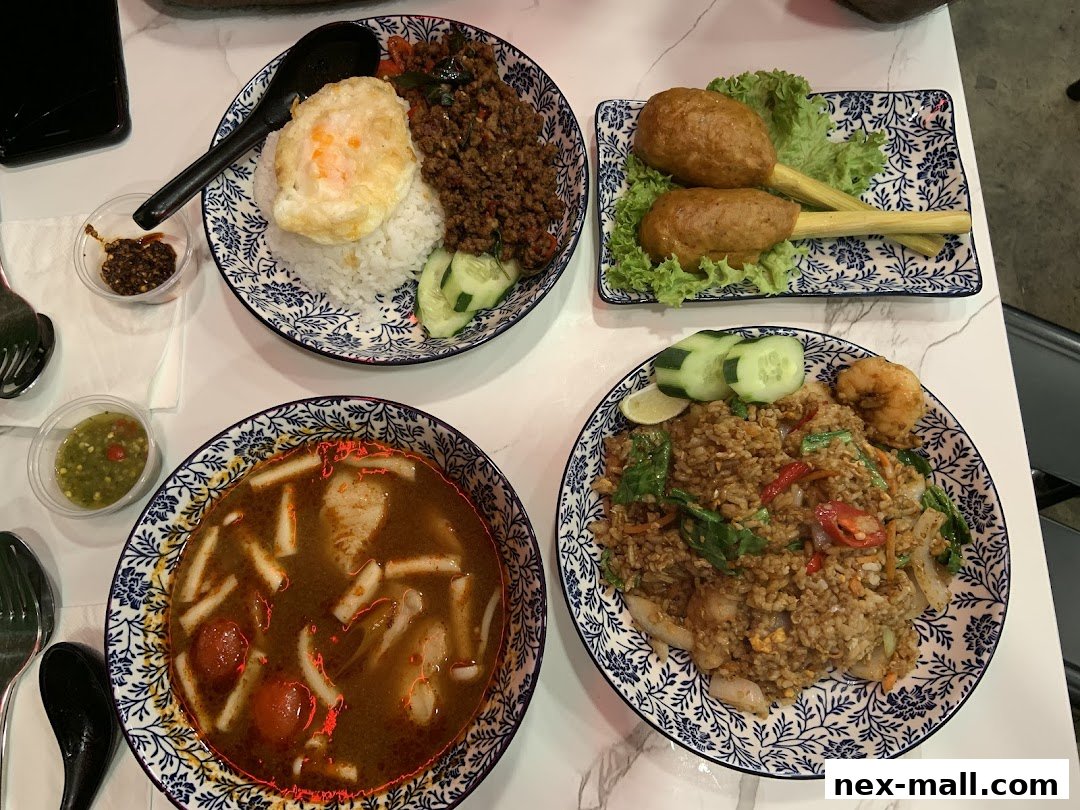 A spread of delicious Thai dishes including fried rice, soup, and appetizers.