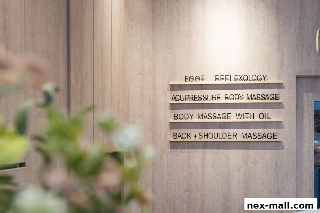 A wall with a list of services offered at a reflexology and massage shop.