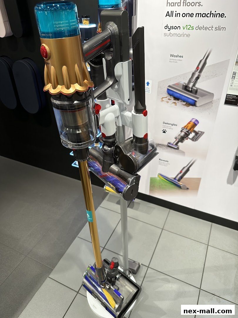A Dyson vacuum cleaner with multiple attachments displayed in a store.