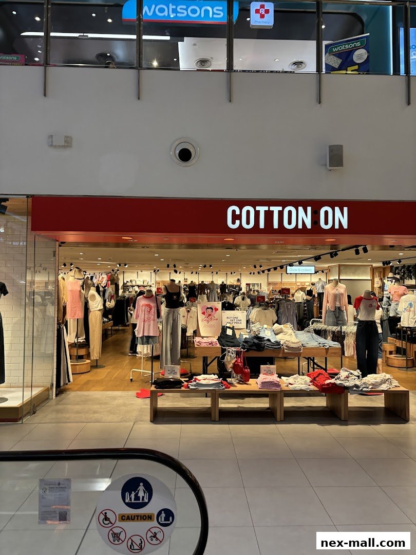 The entrance of a Cotton On store displaying various clothing items and promotions.