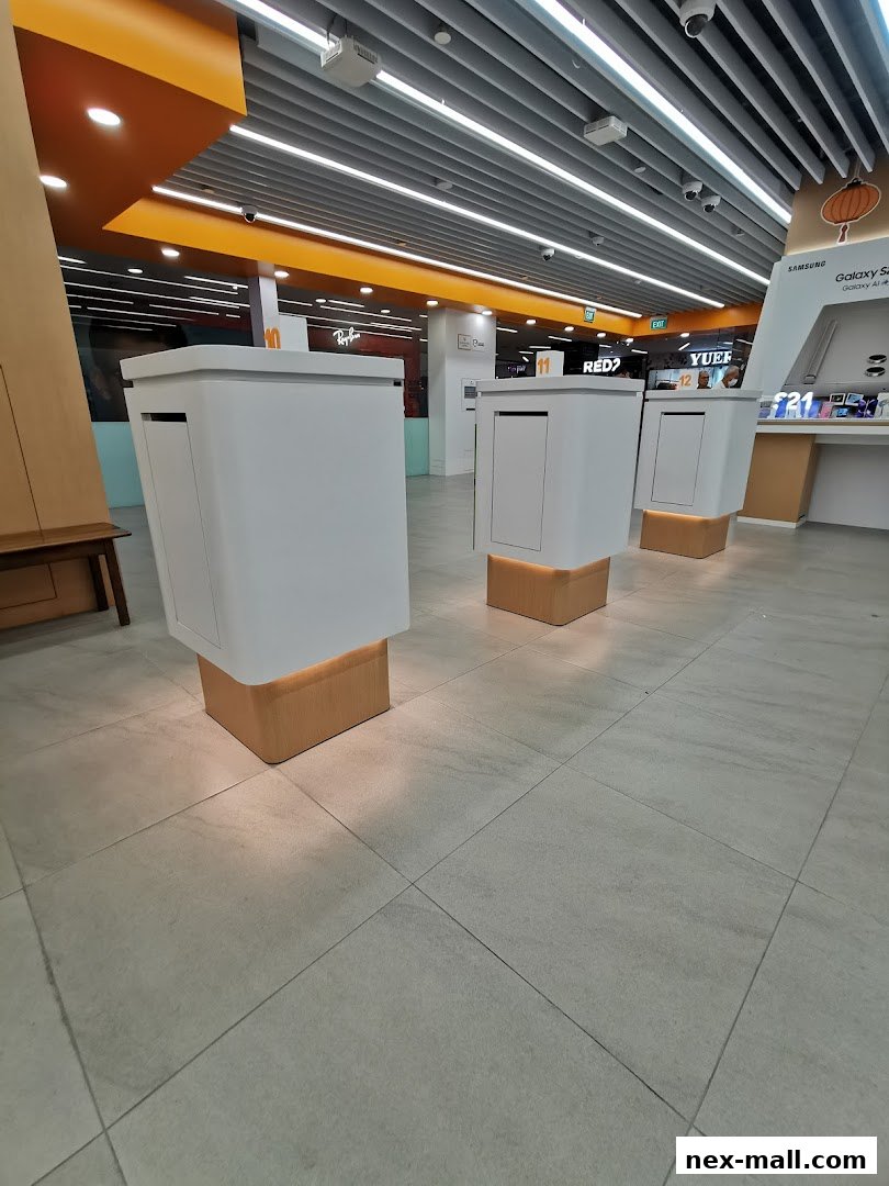 Interior view of a modern phone shop with white display units and bright lighting.