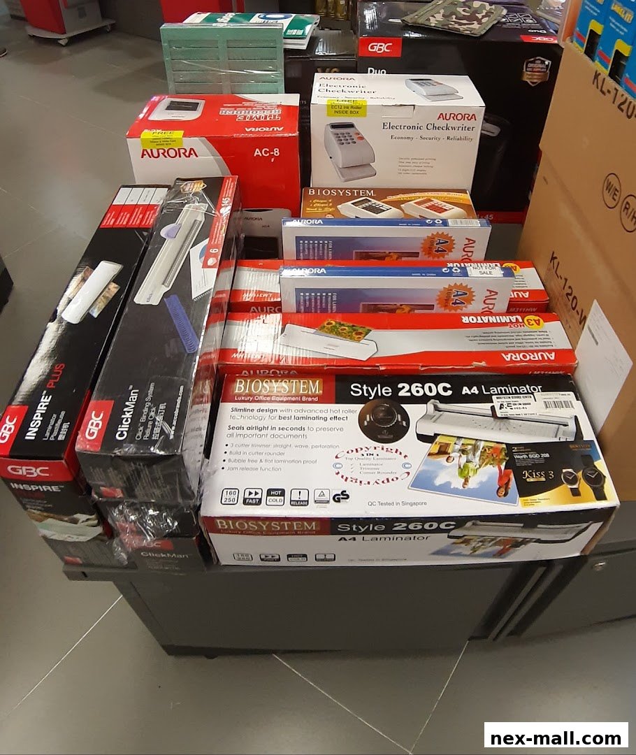 A display of office equipment including laminators, checkwriters, and binding machines.