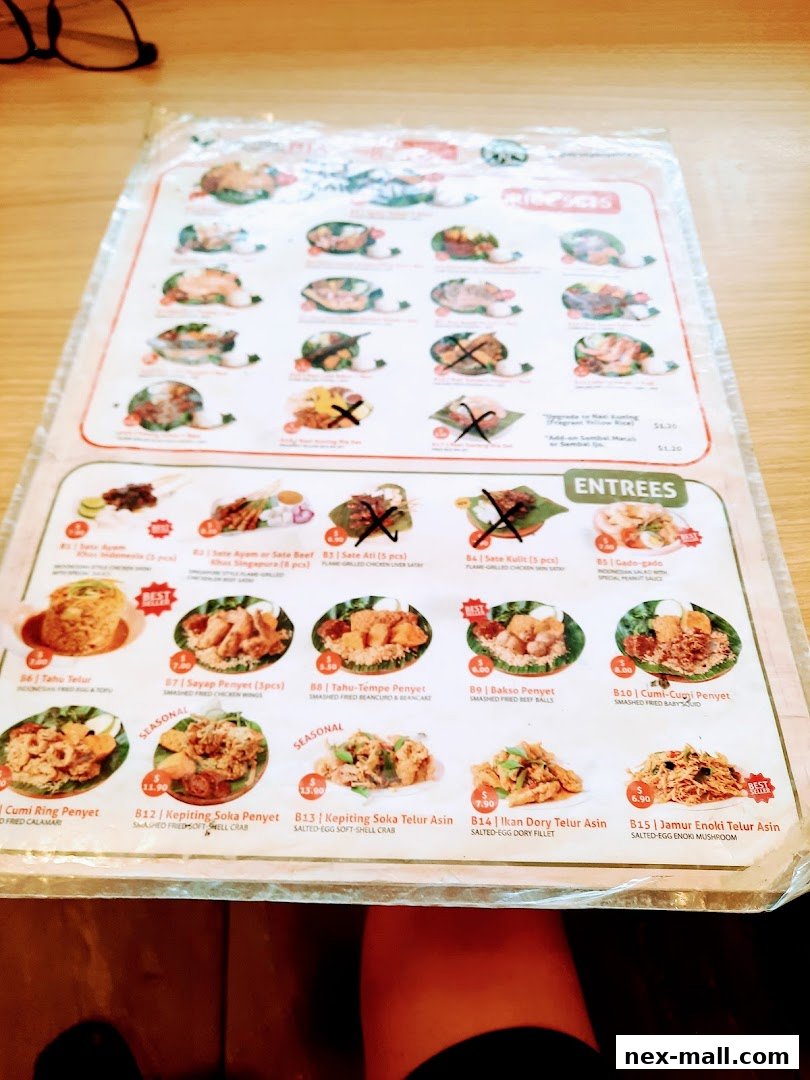 A menu from Ayam Penyet Ria featuring various Indonesian dishes with images and prices.