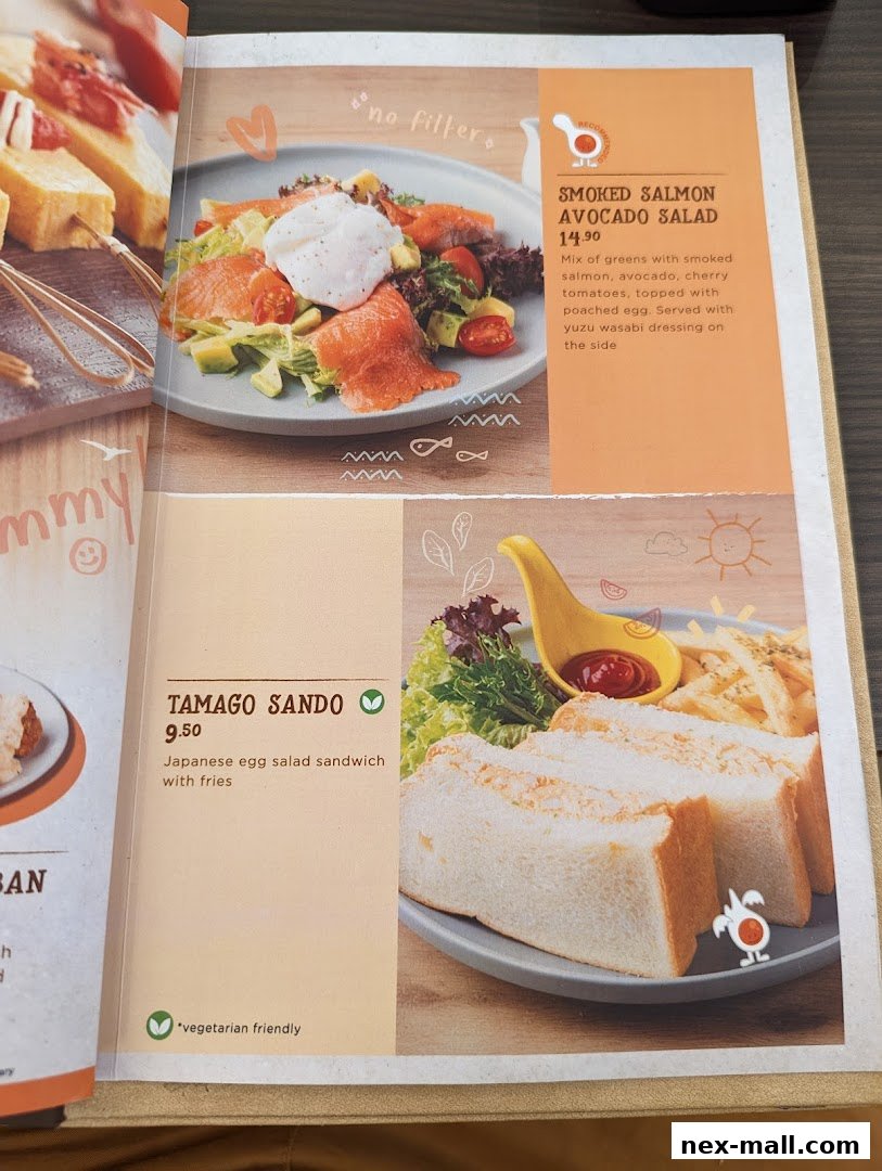 A menu page showcasing two dishes: Smoked Salmon Avocado Salad and Tamago Sando with fries.