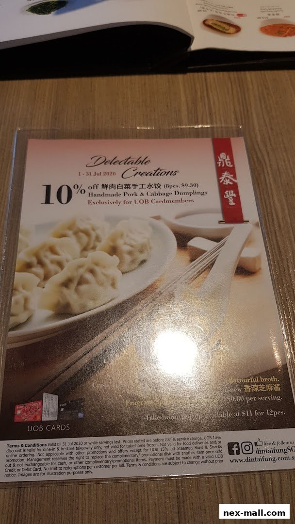 A promotional flyer for Din Tai Fung offering 10% off handmade pork and cabbage dumplings for UOB cardmembers.