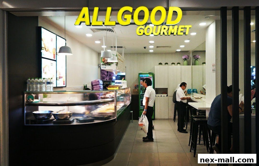 The exterior of the Allgood Gourmet shop with a display counter and customers inside.