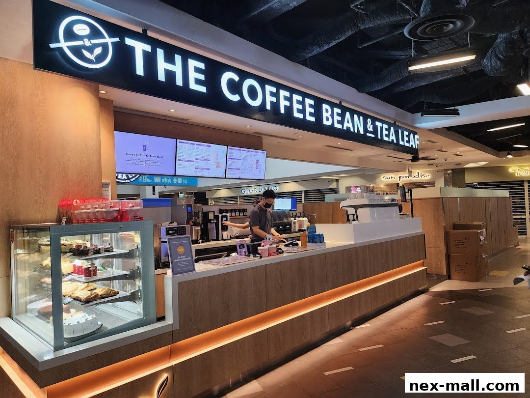 The Coffee Bean & Tea Leaf shop with a display of pastries and a barista preparing drinks.