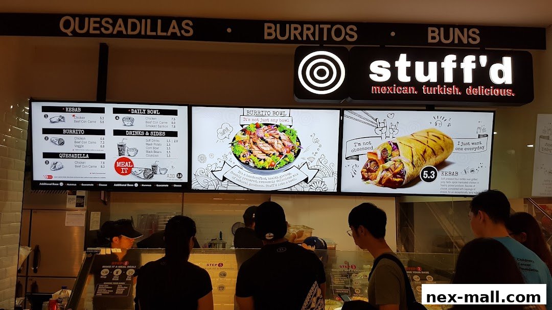 A Stuff'd shop with digital menus displaying kebabs, burritos, quesadillas, and bowls.