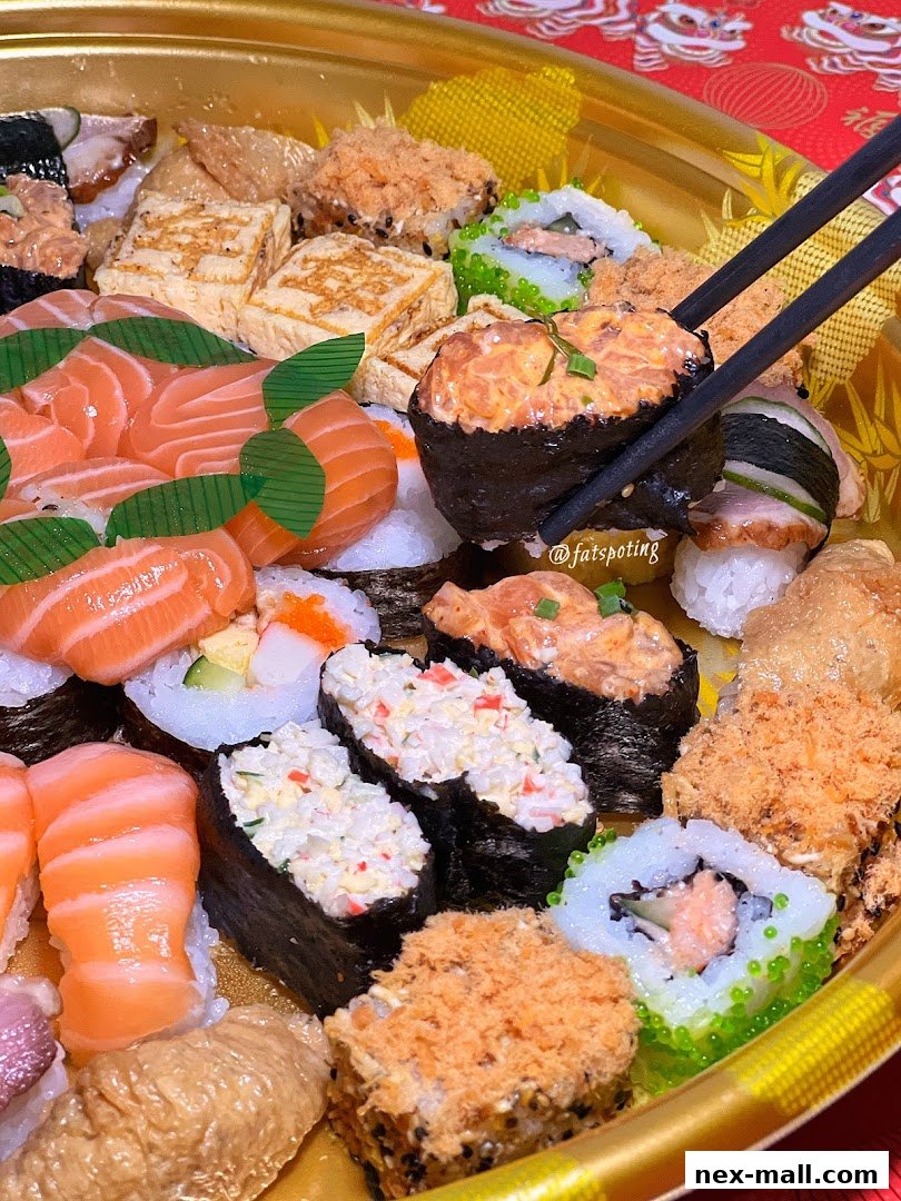 A close-up of a large platter filled with various types of sushi and maki rolls.