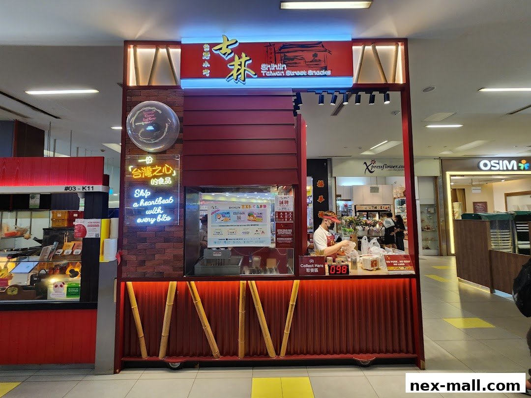 A Shihlin Taiwan Street Snacks stall with a staff member serving customers.