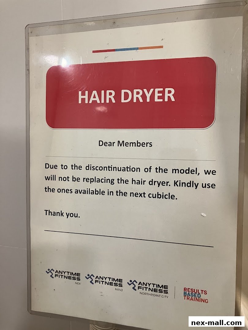 A sign informing members about the discontinuation of hair dryers at Anytime Fitness.