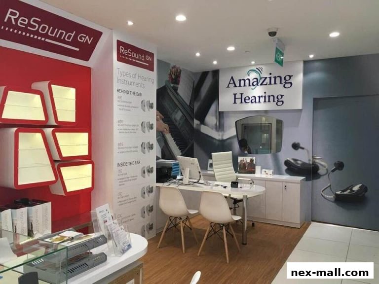 Interior of a hearing aid shop with displays, a reception desk, and hearing instrument information.