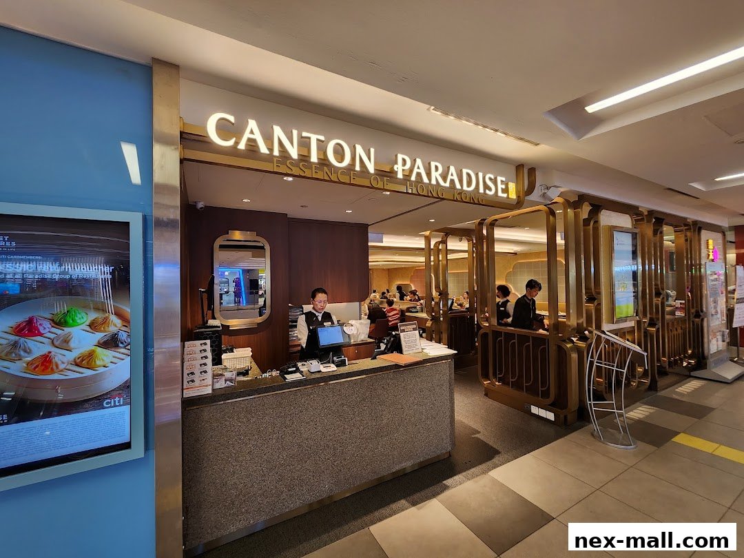 The entrance of Canton Paradise restaurant with staff at the counter and diners inside.