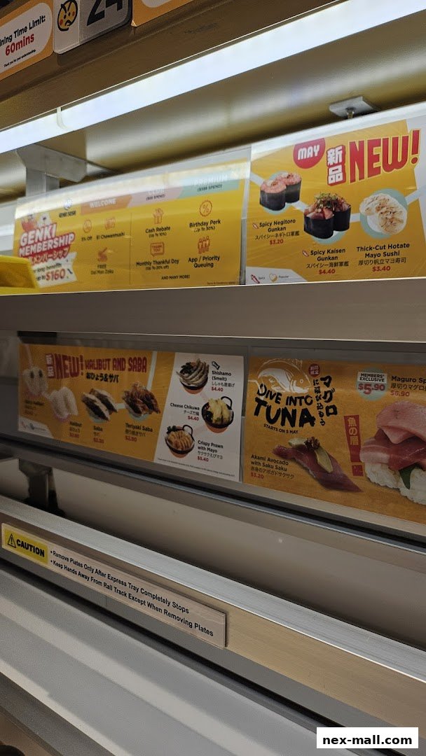 A conveyor belt sushi restaurant display featuring new menu items and membership benefits.